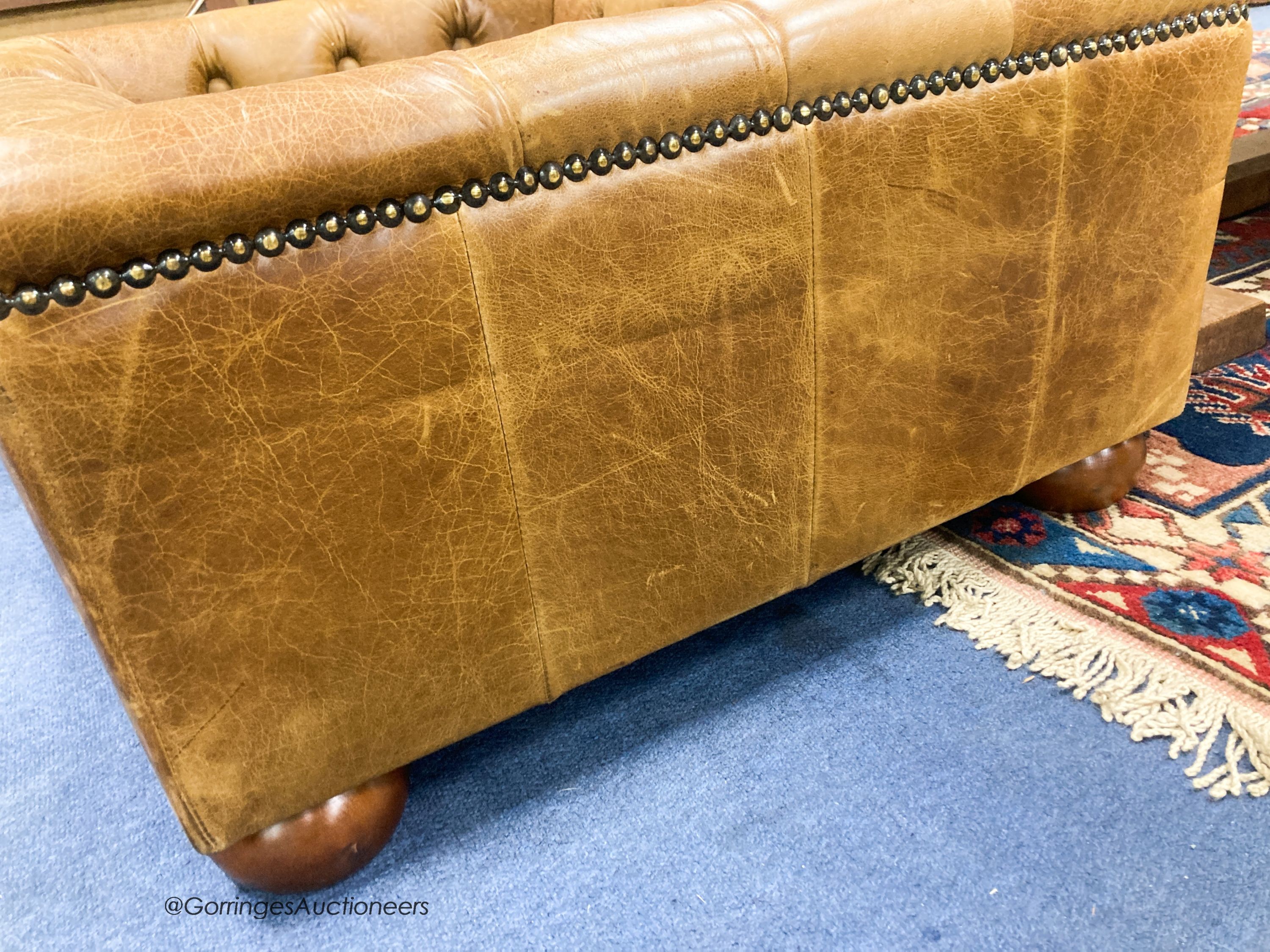 An Italian buttoned tan leather dog's bed with loose cushion, width 84cm, depth 68cm, height 36cm